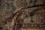 Worn pile, geometric border, and tattered end of a vintage Caucasian rug.