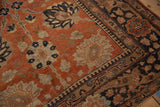 Hand-knotted texture of a vintage Tabriz rug corner with rust palmettes and a detailed dark border.