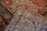 Corner view of a vintage Tabriz rug showing its hand-knotted foundation and low pile.
