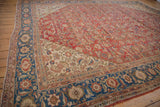 Sultanabad rug corner showing sapphire blue Herati floral border and ivory spandrel.