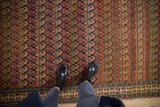 Detail of the antique Bijar's staggered boteh pattern, showing the carpet's evenly worn, low pile.