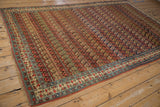 Angled view of a collector's antique Bijar carpet, revealing its dynamic staggered boteh pattern.