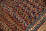 Intricate boteh motifs and low-pile texture of an antique Persian Bijar carpet.