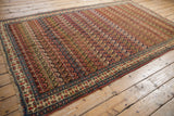 A collectible antique Bijar carpet displaying its dynamic, repeating boteh design.