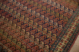Time-softened patina and recessed pile detail the boteh motifs of an antique Persian Bijar carpet.