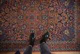 Personal perspective of a vintage Isfahan rug's intricate floral field and evenly worn low pile.