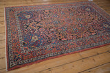 Angled view of a vintage Isfahan rug's complex curvilinear pattern with botehs and blossoms.