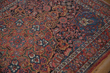 Angled view of the vintage Isfahan rug's dense field of botehs and floral sprays.