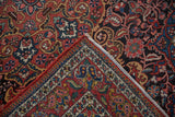 Folded corner of the vintage Isfahan rug revealing its hand-knotted construction and cotton foundation.