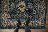 A perspective view from above showing the scale of a vintage Bijar rug's intricate patterns.