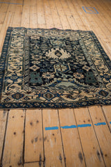 Angled perspective of a vintage Bijar rug displaying its geometric Harshang design in navy and ivory.