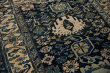 Detail of a vintage Persian Bijar rug showing dense geometric animal and blossom motifs.