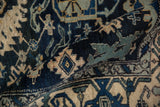 The short, even pile of a vintage Bijar rug with geometric blossoms in navy, ivory, and dusty teal.