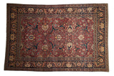 Antique Persian Tabriz carpet with scrolling vinery and palmettes on a cochineal red and navy blue ground.