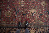 Expressive palmettes and lotus flowers woven with scrolling vinery on a fine antique Tabriz carpet.