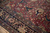 Detailed palmettes and scrolling vinery on the fine, even pile of an antique Tabriz carpet.