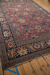 Finely woven corner of an antique Persian Tabriz, detailing the navy palmette border and cochineal red field.