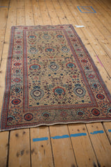 Vintage Tabriz runner corner, with worn sand field, powder blue and brick red palmette motifs.