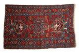 Vintage fine Karaja rug with a central blue medallion and asymmetric motifs on a cherry red field.
