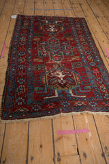Fine Karaja rug seen from an angle, showing mirrored medallions in red and sapphire blue.