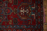 Detail of the vintage Karaja rug's geometric border, showing areas of pile and the intact side selvage.