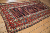 The wide geometric border and dark brown side cord selvage of a vintage Kurd rug.
