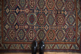 Evenly worn low pile showing the repeating octagonal guls on a vintage Caucasian rug.