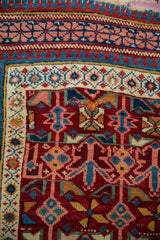 Antique Seichour rug corner showing reciprocating pawn motif borders and tattered end.