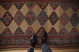 Detail of vintage Kurd runner, featuring serrated geometric guls in camel, dusty rose, and sky blue.