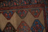 Hand-knotted Kurd rug with serrated geometric guls in blue, red, and abrashed camel.