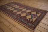 Vintage Kurd runner corner: camel ground with serrated guls, geometric borders, and intact selvage.