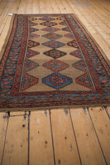 Hand-knotted vintage Kurd runner, geometric serrated guls on an abrashed camel ground.