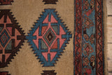 Kurd runner detail: serrated guls in rose, sky blue, camel, and original selvage.