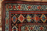 Colorful serrated and meandering vine borders of a vintage Kurd rug with original side cord.