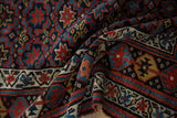 The soft, pliable texture of a hand-knotted Kurd rug with rich, colorful geometric motifs.