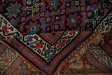 Folded corner of a vintage Kurd rug showing the hand-knotted construction and selvage.