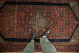 Vintage Farahan Sarouk rug with intricate madder red Herati pattern and ivory diamond medallion.