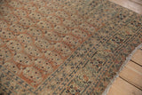 Antique Tabriz rug's pale copper field, intricate botehs, and time-softened floral border.