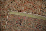 Antique Tabriz rug: hand-knotted foundation, worn terracotta pile, and fringe with pale copper designs.