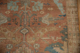 Distressed Malayer rug pile with terracotta, powder blue geometric flowers and side border.