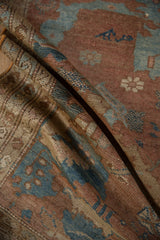Distressed Malayer rug pile showing copper, blue, and ivory checkered floral motifs.
