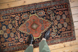 Vintage Persian Mehriban rug's shield medallion, navy field, serrated leaves, and contoured botehs.