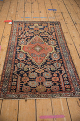 Vintage Mehriban rug close-up: shield medallion, serrated leaves in copper and navy.
