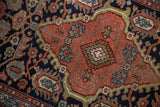 Vintage Mehriban rug detail: dramatically contoured botehs and serrated leaves in copper and navy.