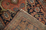 Hand-knotted back and fringe of a Vintage Mehriban rug, detailed front in rust and navy.