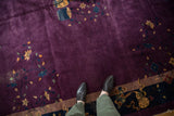 Vintage Nichols carpet's deep plum field featuring gold vines, blue blossoms, and a vase motif.