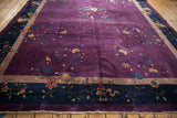 Plum field with delicate vines and blossoms, navy border featuring cloudband scrolls and tan stripe.