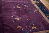 Textured plum field of a vintage Nichols carpet with delicate gold blossoms and blue vines.