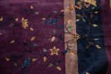 Detail of plum rug field with gold and blue floral vines; visible recessed pile exposing white knots.
