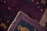 Corner of vintage Chinese Nichols carpet, plum pile, delicate floral vines, and hand-knotted foundation.